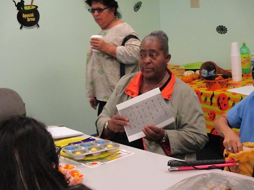 Miss Lolita is directing the Braille Club activities.